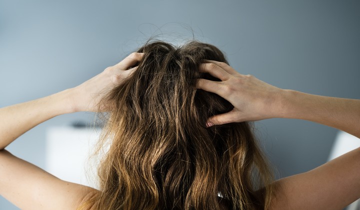 Woman with itchy scalp Woman with itchy scalp