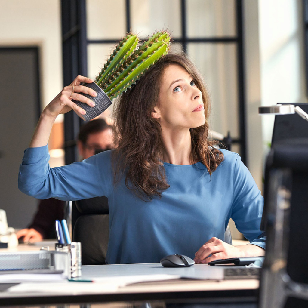 Woman scratching scalp with cactus